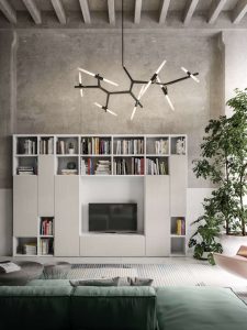 Composizione a spalla di un soggiorno uso libreria e porta tv, dove si alternano vani a giorno e ante.